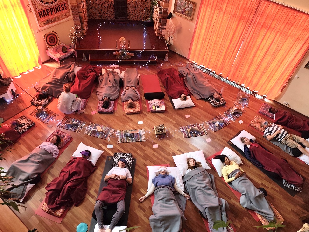 Women resting under blankets during a Yoga Nidra deep rest session
