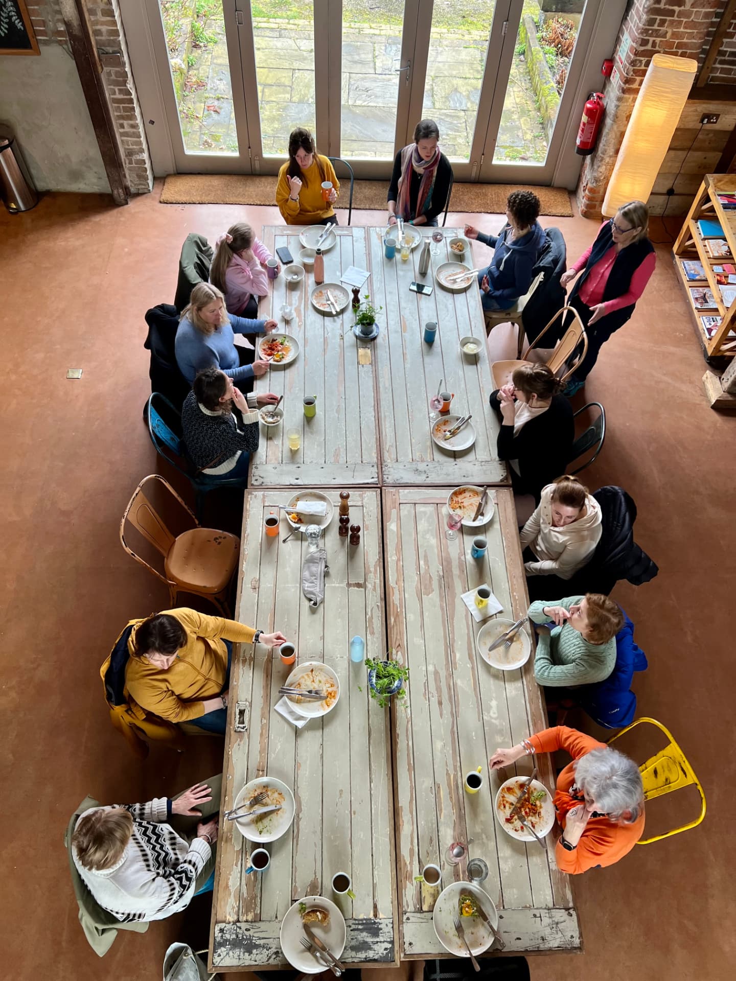 Retreat guests sharing a plant-based lunch at the long table, West Lexham