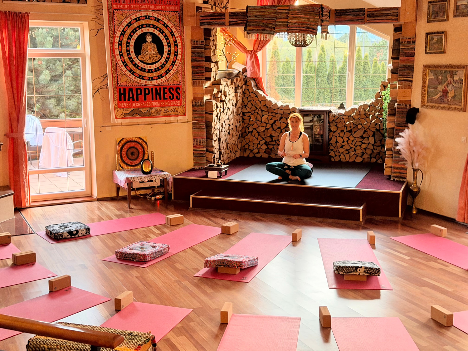 Julia sitting in the yoga shala at Edenium Chalet, where the Deep Rest retreat will be held