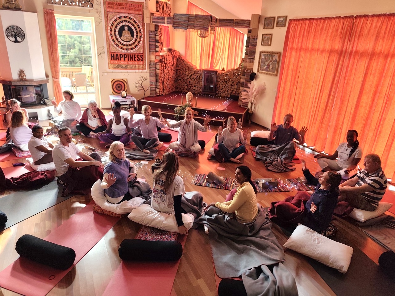 Candlelit evening circle in the yoga hall at Edenium