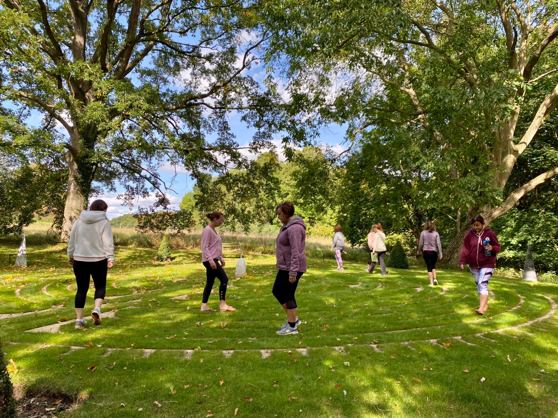 Women walking the labyrinth in the grounds of Tofte Manor