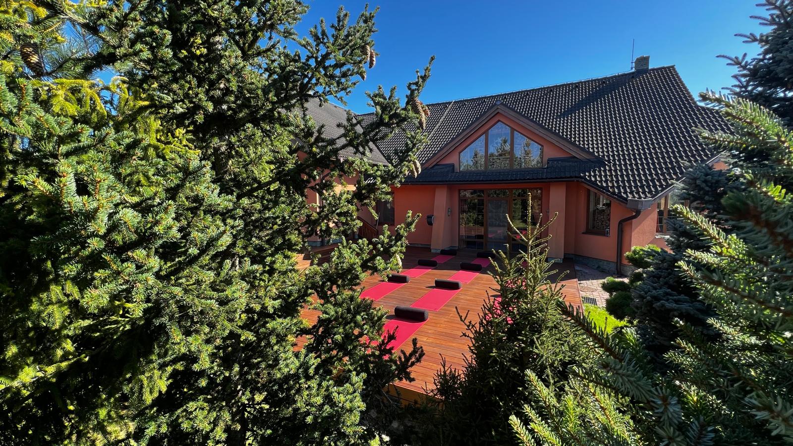 Edenium Chalet exterior with a wooden yoga deck and cushions