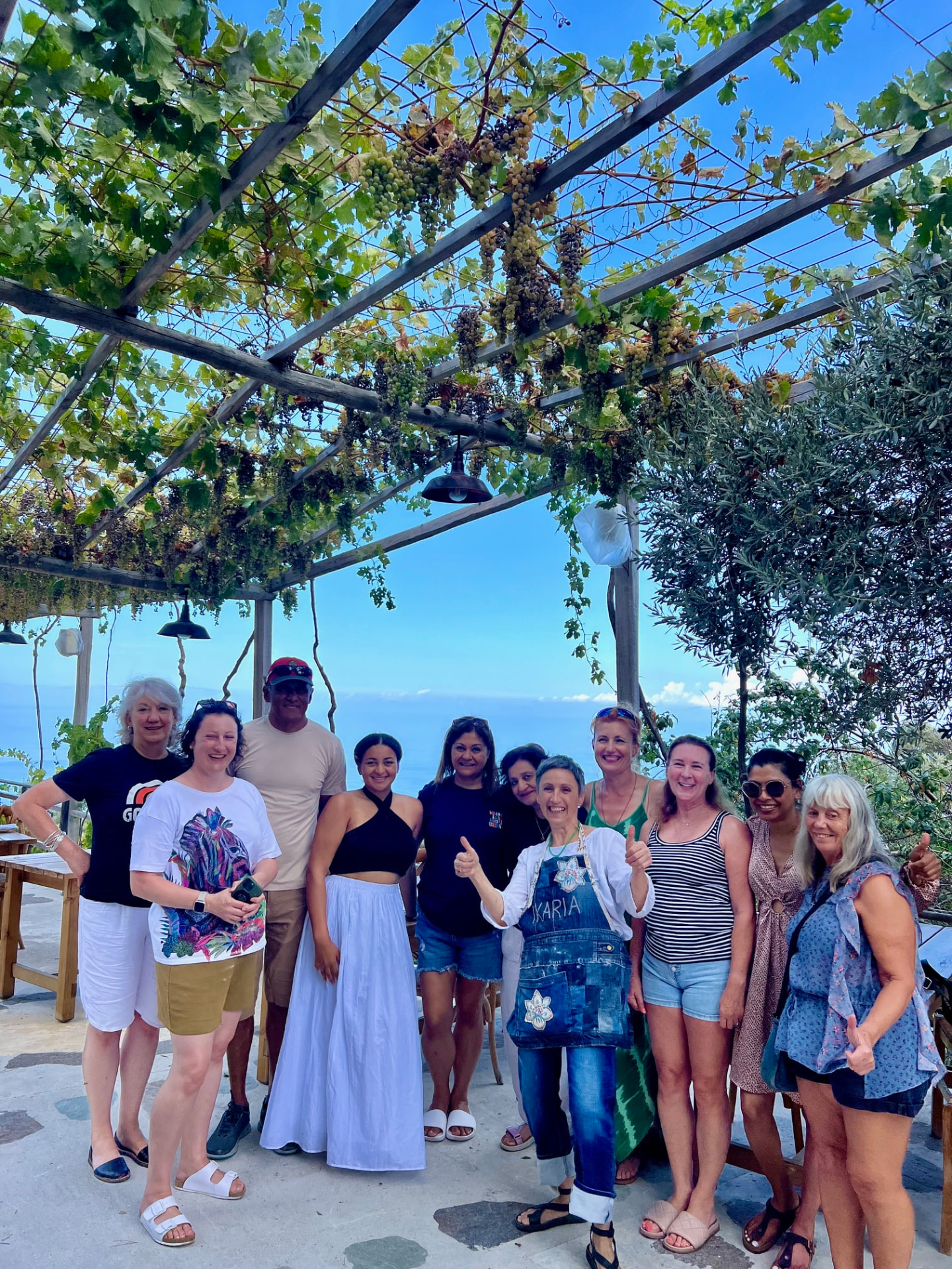 Retreat group under the vine pergola at Kalimaris Winery, Ikaria