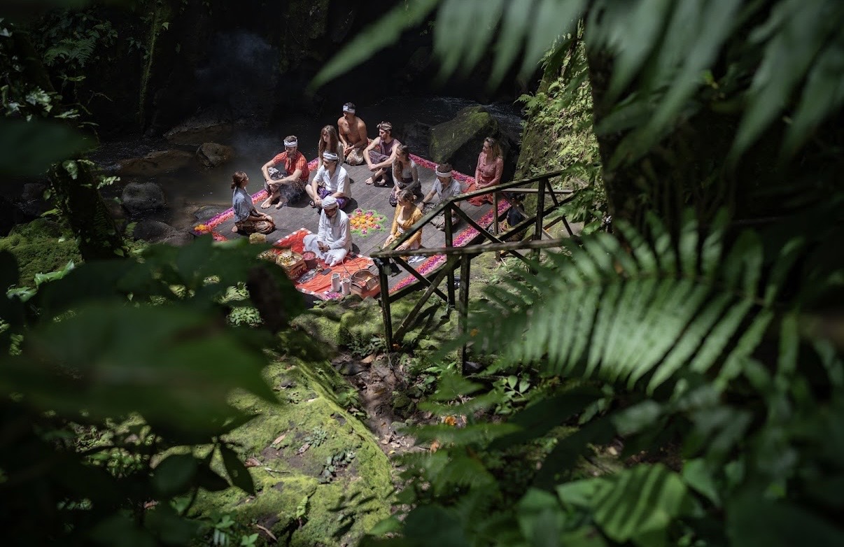 Retreat guests gathered by the river gorge for a Balinese ceremony